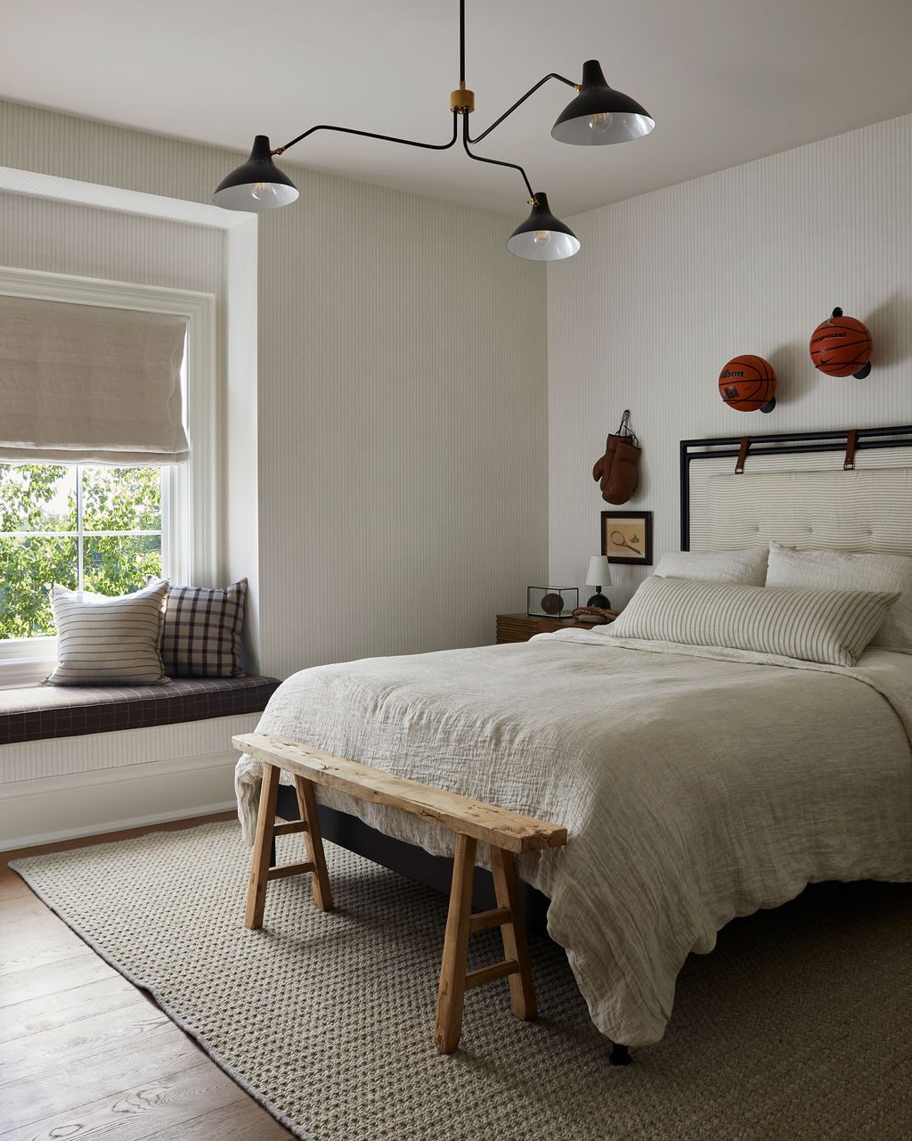 Bedroom with a natural linen relaxed Roman shade above a window seat