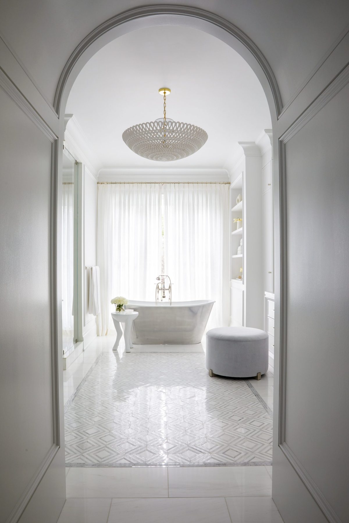 Arched hallway to a bathroom with sheers