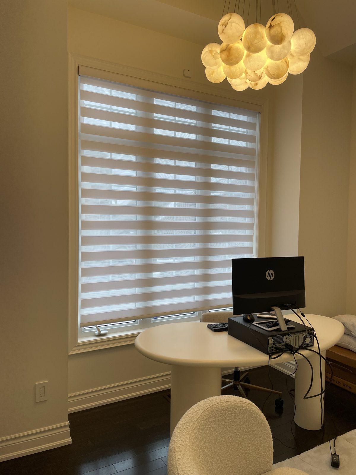 Home office with a zebra blind at a large window
