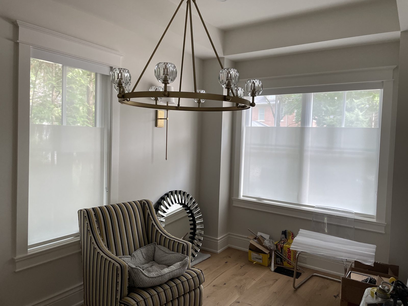 Sitting room with bottom-up shades covering the lower half of two windows
