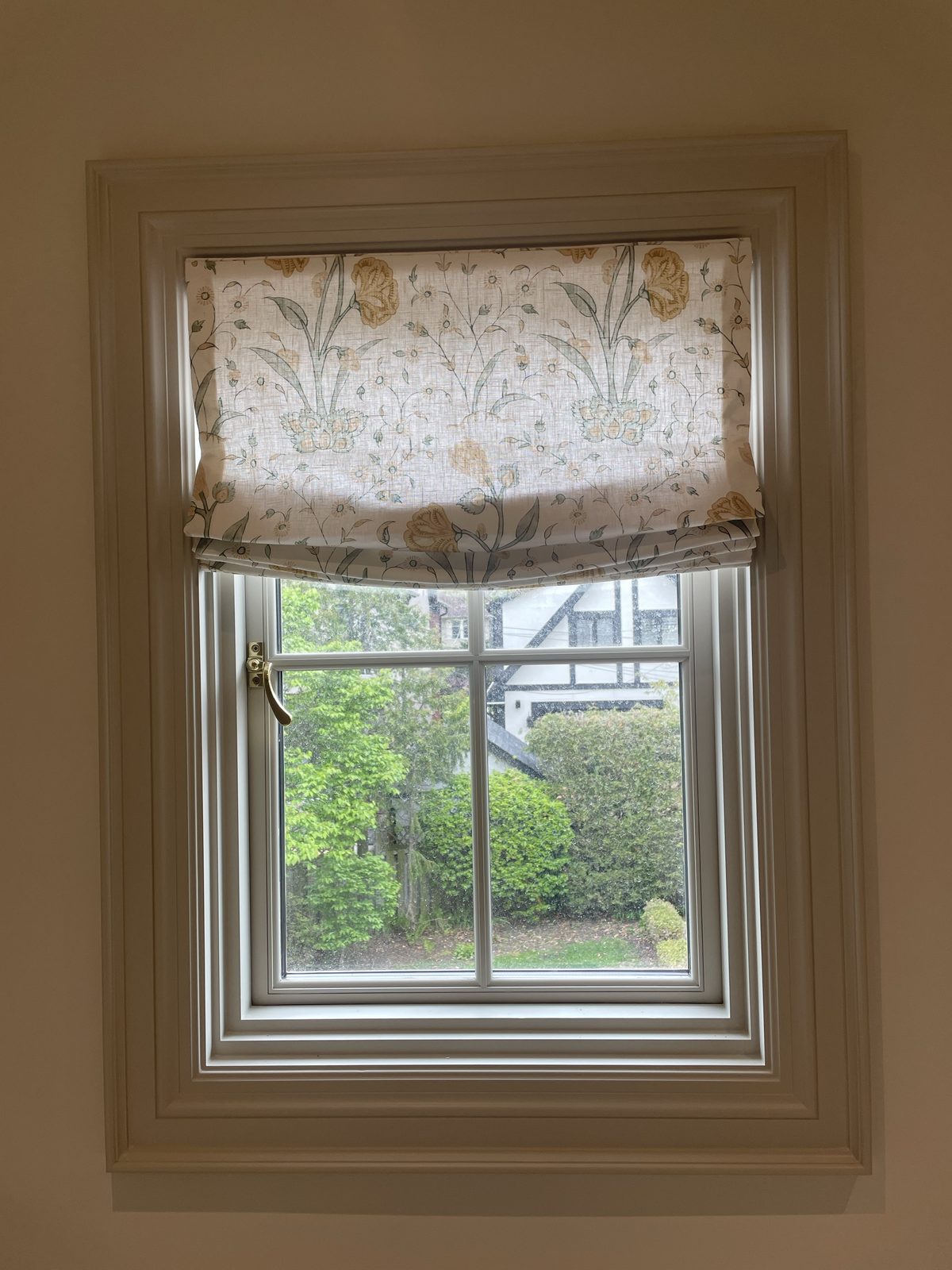 Window with patterned roman shade